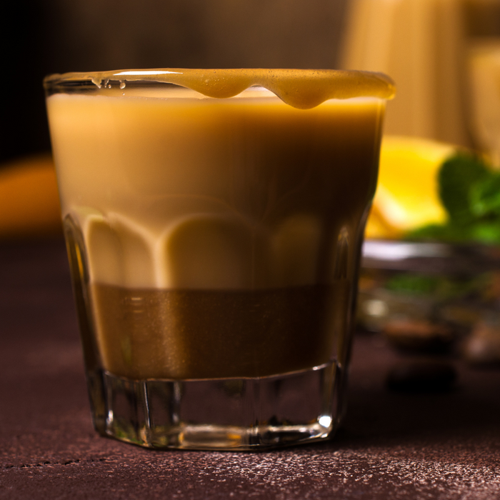 A glass of golden cappuccino.